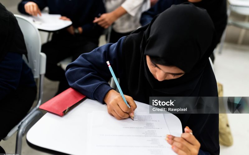 diverse muslim children studying in classroom